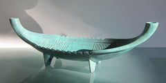 an 18" long green bronze center piece / candle holder inspired by a viking ship