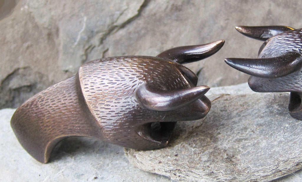 a dark bronze bull shaped bottle opener