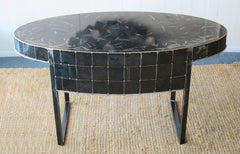 a hand made oval shaped black steel table by Peter Diepenbrock